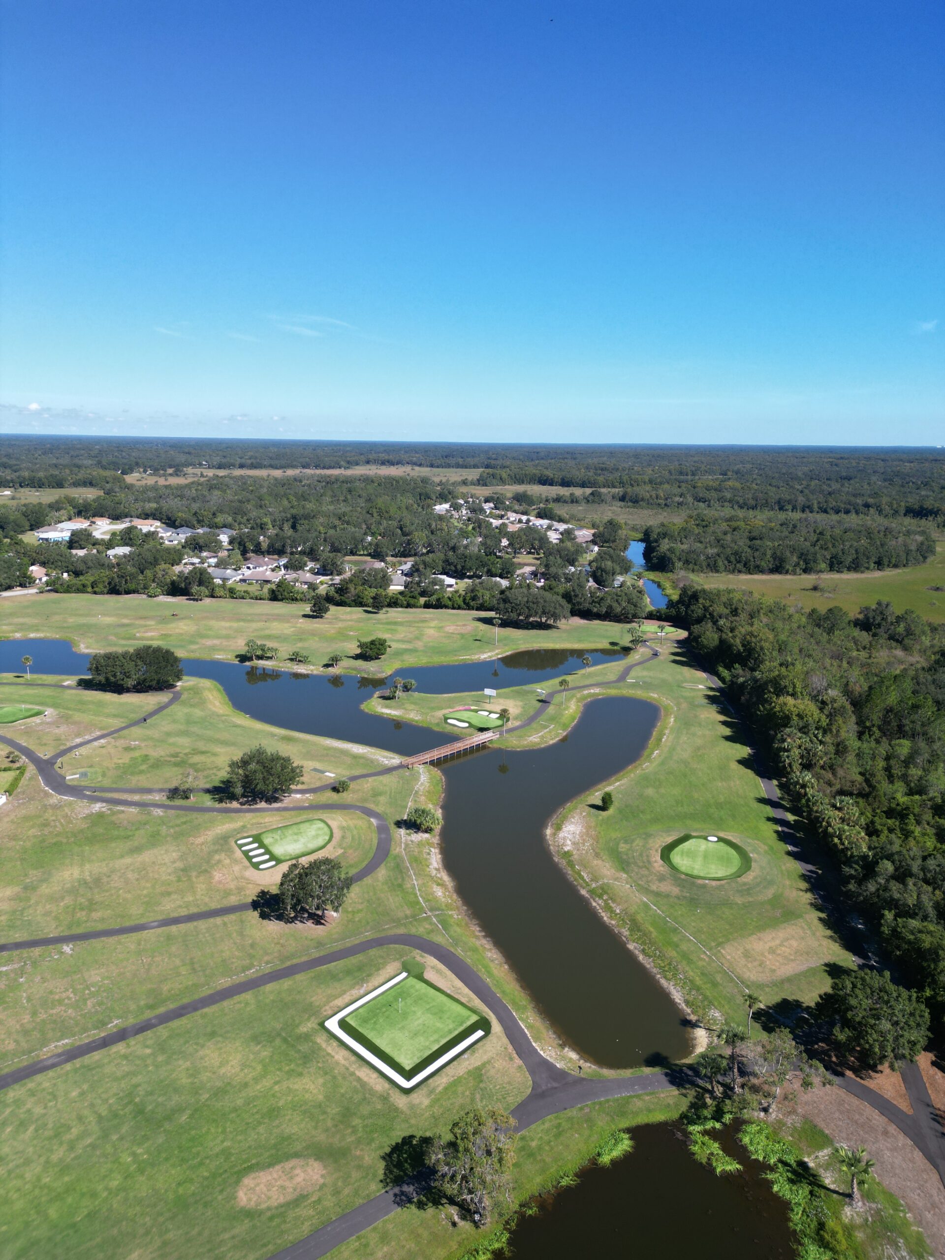 Aerial view of the greens and waterways at ZenWoods Golf Club